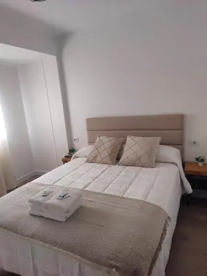a large bed with two trays on top of it at O Lar da Muralla in Lugo