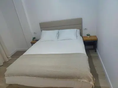 a bed with white sheets and pillows in a room at O Lar da Muralla in Lugo