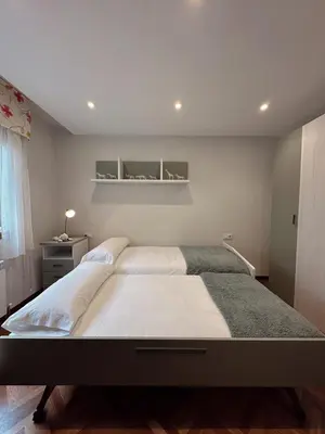 a bedroom with a large bed and a window at Apartamento Villaluz in Monforte de Lemos