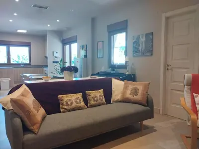a living room with a couch with pillows on it at La casita del bosque in Lugo