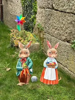 two figurines of rabbits standing in the grass at A Xanela, Casa dos Mestres in Trasmiras