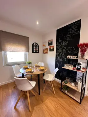 a dining room with a table and chairs and a chalkboard at Las candelas in Astorga