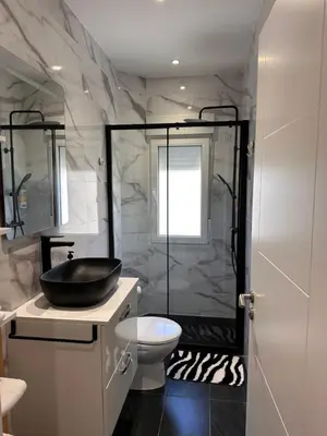 a bathroom with a toilet and a sink and a shower at Las candelas in Astorga