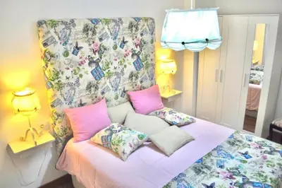 a bedroom with a bed with pink pillows at Curros Enríquez RD, Céntrico, PLAZA GARAGE in Ourense