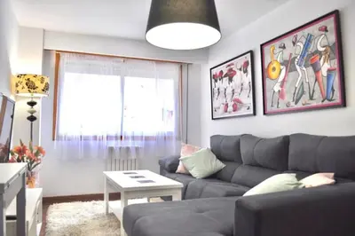 a living room with a couch and a table at Curros Enríquez RD, Céntrico, PLAZA GARAGE in Ourense