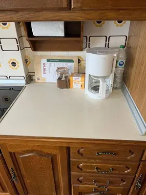a kitchen counter with a coffee maker on it at Apartamento DENTRO DE MURALLA y PARKING GRATUITO en pleno centro in Lugo