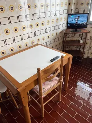a table with a remote control sitting on top of it at Apartamento DENTRO DE MURALLA y PARKING GRATUITO en pleno centro in Lugo