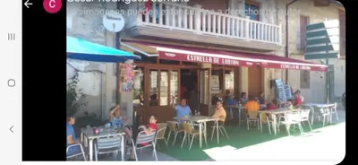 a group of people sitting at tables outside a restaurant at Buhardilla Cesar in Lubián