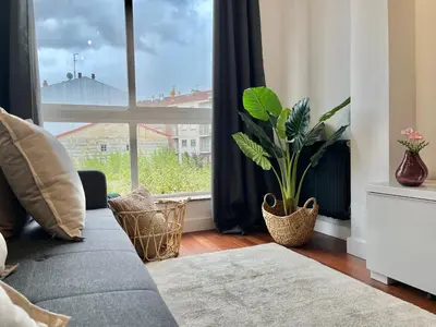a living room with a couch and a large window at Nuevo Piso en Couto in Ourense