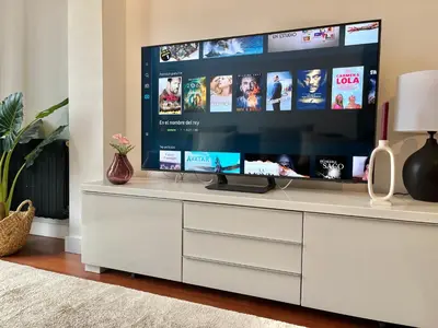 a white entertainment center with a large screen tv in a living room at Nuevo Piso en Couto in Ourense