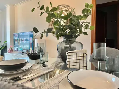 a glass table with a vase with a plant in it at Nuevo Piso en Couto in Ourense