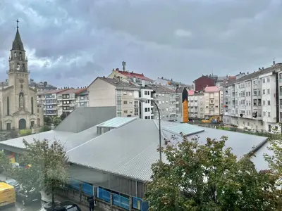 a view of a city with a building and a church at Nuevo Piso en Couto in Ourense