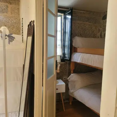 a room with bunk beds and a window at El Abuelo Angel in Ribadavia