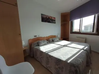 a bedroom with a bed and a window at Fogar do Vento-Ordes, cerca de Camino Inglés Bruma in Ordes