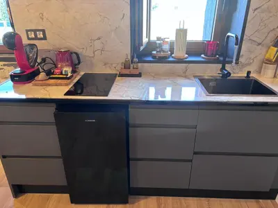 a kitchen counter with a sink and a laptop on it at 27A01 Casa Uría Cam Santiago by R2R Consulting in Berducedo