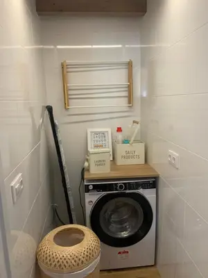 a laundry room with a washing machine and a toilet at A chousa da folgueira in Ordes
