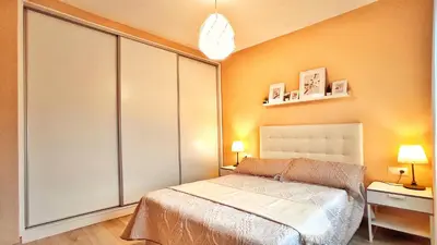 a bedroom with a bed and a large closet at Casa en Cortiñan in Bergondo