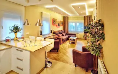 a living room with a kitchen and a living room with a couch at Casa en Cortiñan in Bergondo