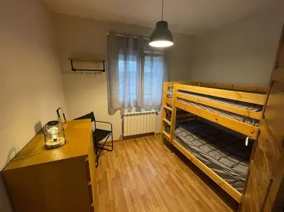 a small room with a bunk bed and a desk at Casa da Baltasara in Trives