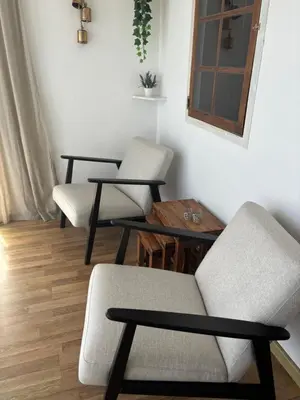 two chairs and a table in a room at Casa da Baltasara in Trives
