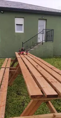 a wooden picnic table in front of a house at Casa da Baltasara in Trives