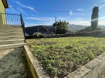 a set of stairs leading up to a field of grass at Casa da Baltasara in Trives