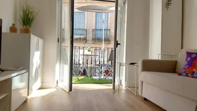 a living room with a couch and an open door at casa Chloe in Ourense