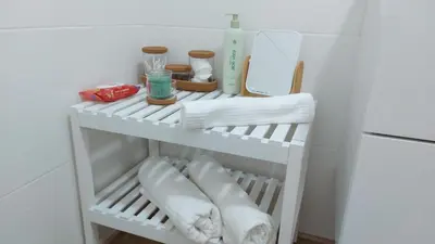 a white refrigerator with towels on a shelf at casa Chloe in Ourense