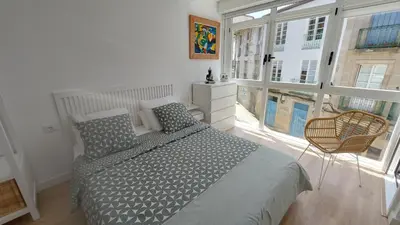 a bedroom with a bed and a large window at casa Chloe in Ourense