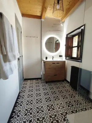 a bathroom with a sink and a mirror at La Escondida VuT-LE-952 in Caboalles de Abajo