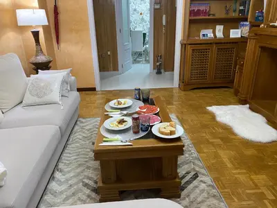 a living room with a table with plates of food on it at Army Deluxe in Astorga