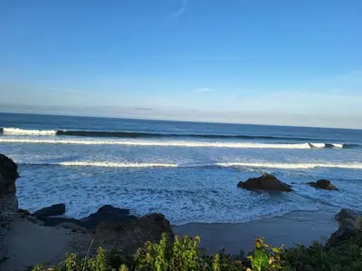 a view of the ocean with some waves at BARREIROS RUA Vila in Barreiros