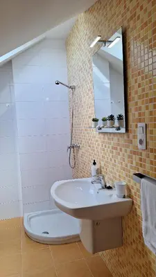 a bathroom with a sink and a mirror on a wall at BARREIROS RUA Vila in Barreiros