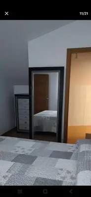a bedroom with a mirror and a bed and a dresser at BARREIROS RUA Vila in Barreiros