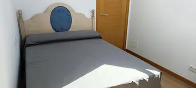 a bed with a blue headboard in a bedroom at BARREIROS RUA Vila in Barreiros