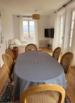 a dining room with a table and chairs and a couch at Apartamento en plaza de Ribadeo in Ribadeo