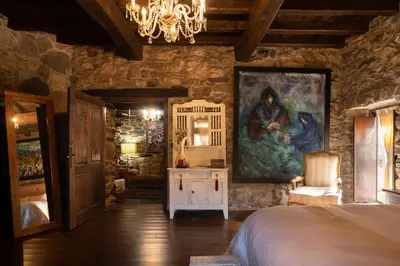 a bedroom with a large painting on the wall at Casa Muíñovedro in Chantada