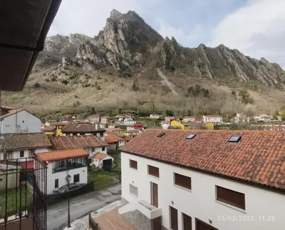 a view of a town with a mountain in the background at Ceraca in Pola de Somiedo