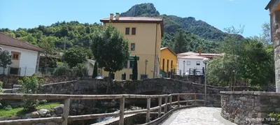 a small village with a building and a bridge at Ceraca in Pola de Somiedo
