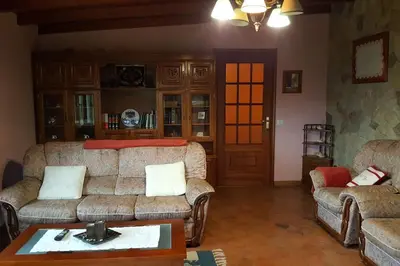 a living room with two couches and a table at Chalet en Miño con vistas al mar in Miño