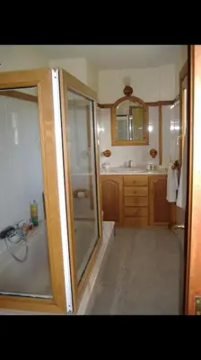 a bathroom with a shower and a tub and a sink at Chalet en Miño con vistas al mar in Miño