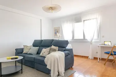 a living room with a blue couch and a table at Senel Home in Boimorto