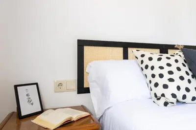a bedroom with a bed and a book on a table at Senel Home in Boimorto