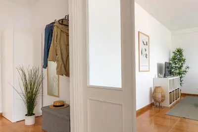 a hallway with a door and a living room at Senel Home in Boimorto