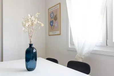 a blue vase with flowers sitting on a table at Senel Home in Boimorto