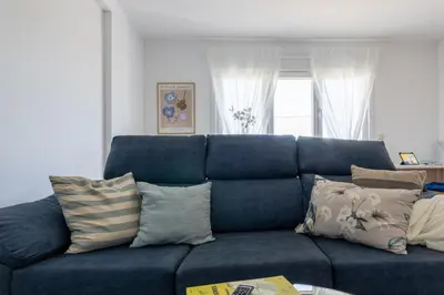 a blue couch with pillows in a living room at Senel Home in Boimorto