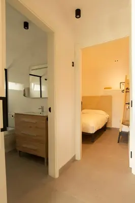 a bedroom with a bed and a sink and a mirror at Apartamentos Camino Inglés II in Ordes