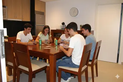 a group of people sitting around a wooden table at Apartamentos Camino Inglés II in Ordes