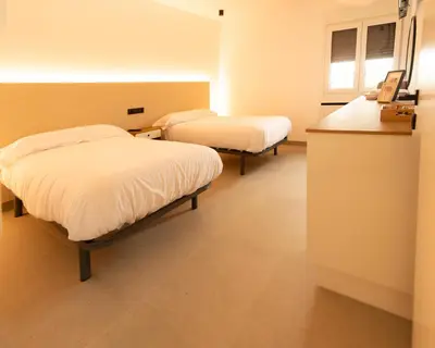 a hospital room with two beds and a counter at Apartamentos Camino Inglés II in Ordes