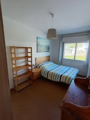 a bedroom with a bed and a window at Mira a Parque in Lugo